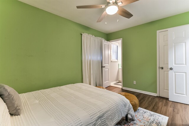 bedroom with baseboards, wood finished floors, and a ceiling fan
