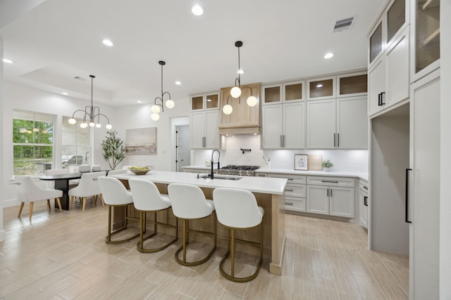 1252 Rd 6604, Dayton, TX 77535 - kitchen featuring a sink, backsplash, light countertops, recessed lighting, and an island with sink