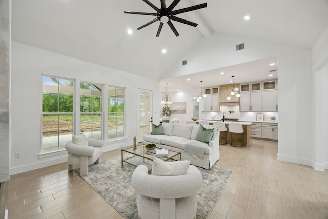1252 Rd 6604, Dayton, TX 77535 - living area featuring beam ceiling, a ceiling fan, high vaulted ceiling, baseboards, and light wood finished floors