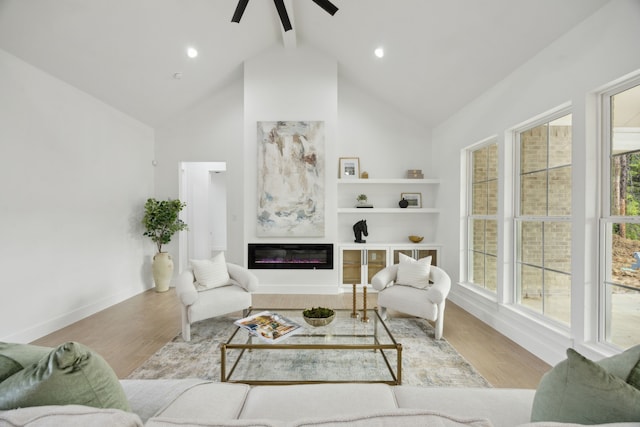 1252 Rd 6604, Dayton, TX 77535 - living area featuring high vaulted ceiling, a ceiling fan, beamed ceiling, wood finished floors, and built in shelves
