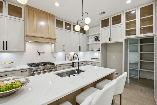 1252 Rd 6604, Dayton, TX 77535 - kitchen with a sink, open shelves, stainless steel range, tasteful backsplash, and recessed lighting