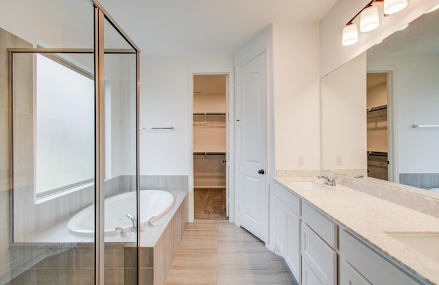 693 Cape Capri Dr, Katy, TX 77493 - bathroom with tile patterned flooring, a shower stall, a sink, double vanity, and a bath