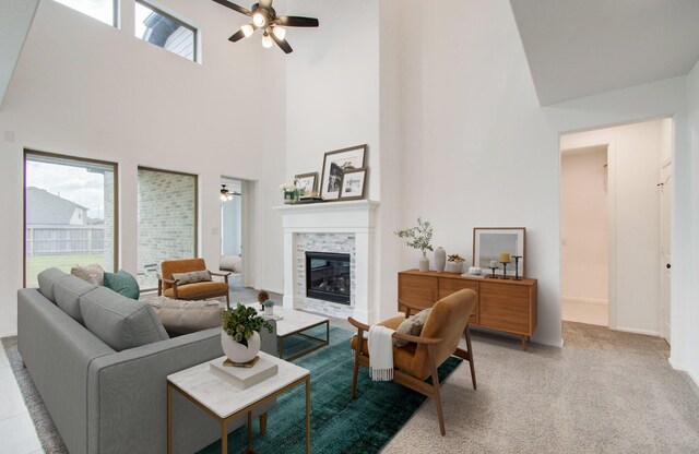 693 Cape Capri Dr, Katy, TX 77493 - carpeted living area with baseboards, a fireplace, a towering ceiling, and a ceiling fan