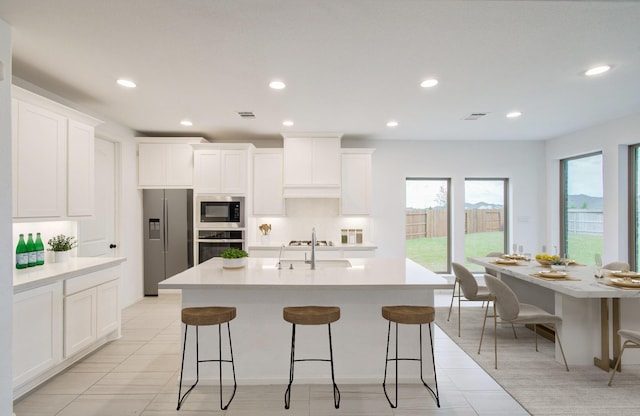 693 Cape Capri Dr, Katy, TX 77493 - kitchen with a sink, visible vents, appliances with stainless steel finishes, and white cabinetry