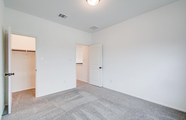 693 Cape Capri Dr, Katy, TX 77493 - unfurnished bedroom featuring baseboards, carpet flooring, visible vents, and a spacious closet