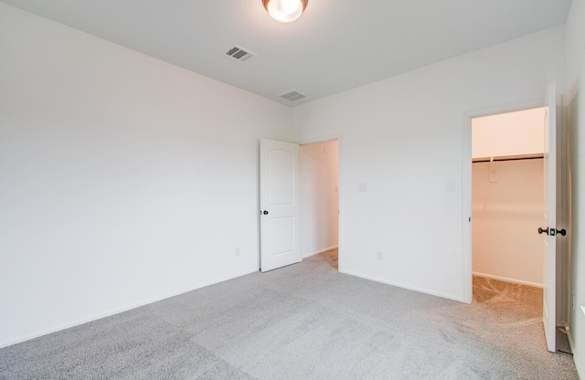 693 Cape Capri Dr, Katy, TX 77493 - unfurnished bedroom featuring a closet, a spacious closet, baseboards, visible vents, and carpet