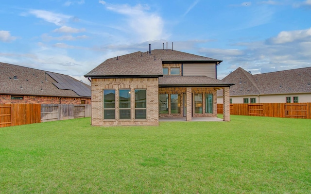 693 Cape Capri Dr, Katy, TX 77493 - rear view of property featuring a fenced backyard, a lawn, a shingled roof, and a patio