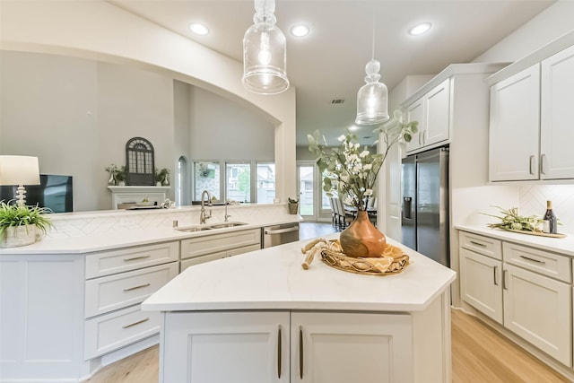 17429 Orchid Falls Ln, Conroe, TX 77302 - kitchen with a sink, appliances with stainless steel finishes, light countertops, a kitchen island, and recessed lighting