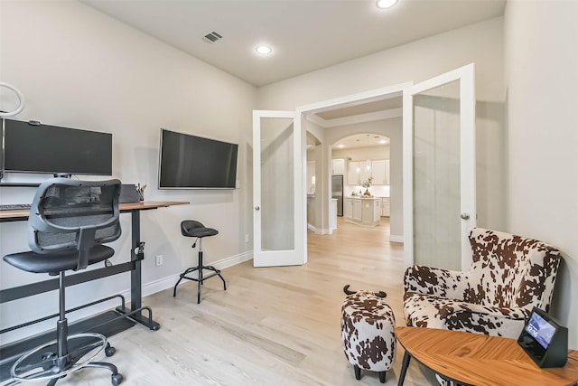 17429 Orchid Falls Ln, Conroe, TX 77302 - office area featuring wood finished floors, baseboards, and arched walkways