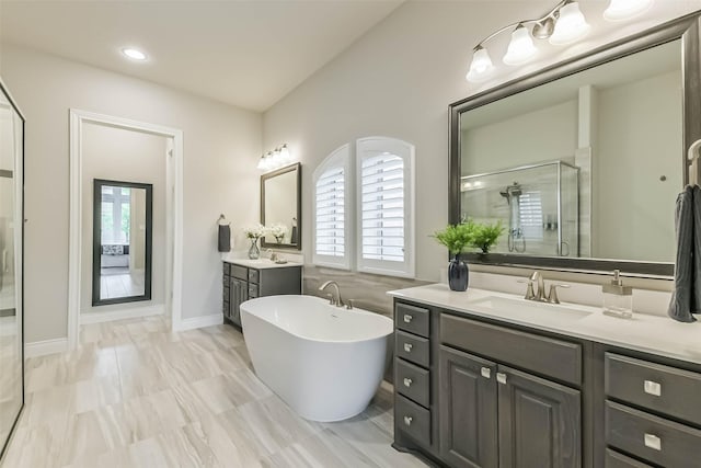 17429 Orchid Falls Ln, Conroe, TX 77302 - full bathroom featuring a stall shower, two vanities, a soaking tub, and recessed lighting