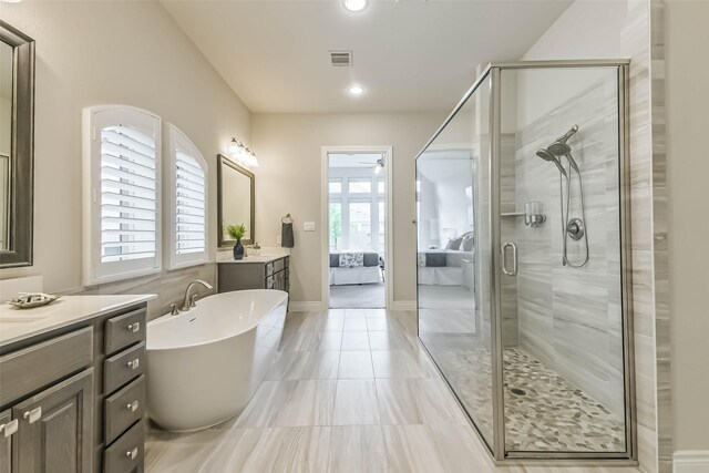17429 Orchid Falls Ln, Conroe, TX 77302 - bathroom featuring connected bathroom, vanity, healthy amount of natural light, a shower stall, and recessed lighting