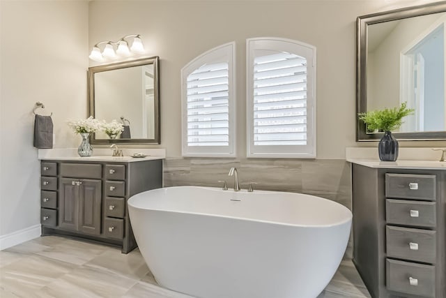 17429 Orchid Falls Ln, Conroe, TX 77302 - full bathroom featuring a soaking tub, vanity, and tile walls