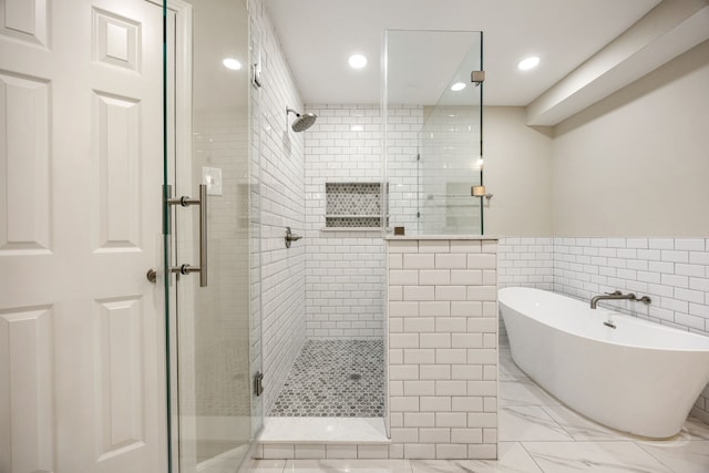 11814 Drexelbrook Dr, Houston, TX 77077 - bathroom with a tile shower, a soaking tub, tile walls, recessed lighting, and a wainscoted wall