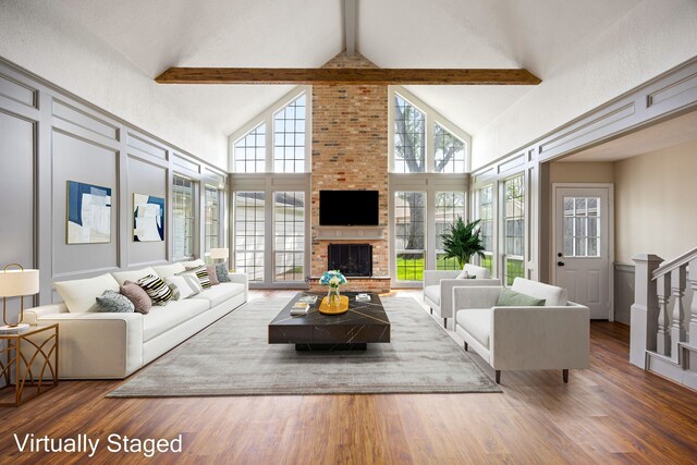 11814 Drexelbrook Dr, Houston, TX 77077 - living room featuring high vaulted ceiling, healthy amount of natural light, beam ceiling, wood finished floors, and a fireplace