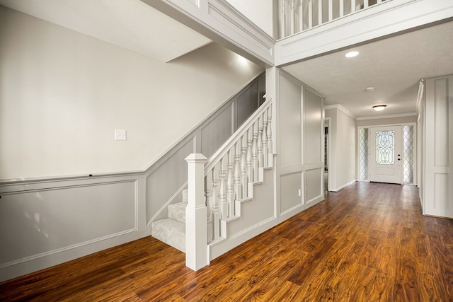 11814 Drexelbrook Dr, Houston, TX 77077 - staircase featuring a decorative wall, crown molding, wood finished floors, and recessed lighting