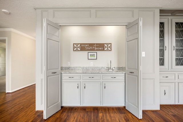 11814 Drexelbrook Dr, Houston, TX 77077 - indoor bar featuring crown molding and dark wood-type flooring