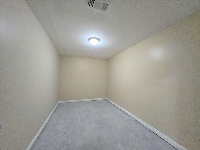 unfurnished room featuring baseboards and visible vents