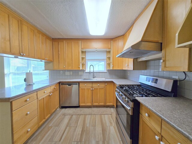 kitchen with a sink, open shelves, appliances with stainless steel finishes, under cabinet range hood, and decorative backsplash