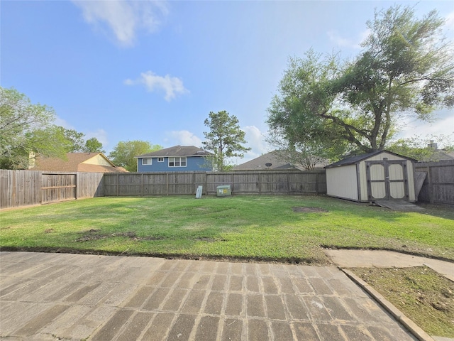 view of yard featuring a fenced backyard, an outbuilding, and a storage shed