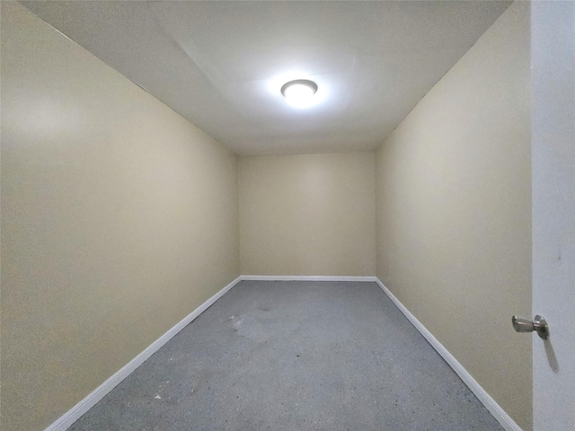 empty room featuring baseboards and concrete floors