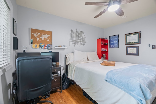 bedroom with a ceiling fan and wood finished floors