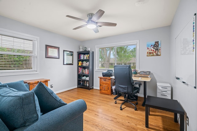 home office with light wood-style floors, baseboards, and ceiling fan