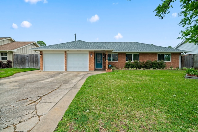 single story home with fence, an attached garage, concrete driveway, and brick siding