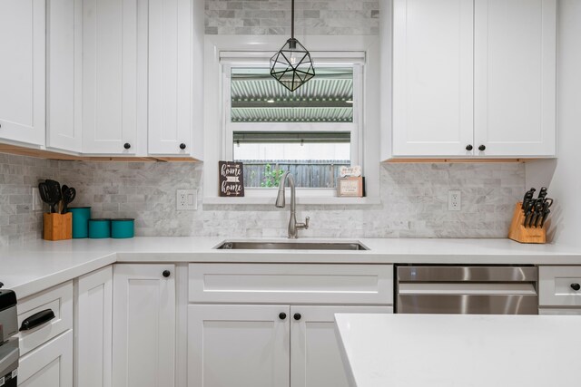 kitchen featuring a sink, light countertops, white cabinets, and stainless steel dishwasher