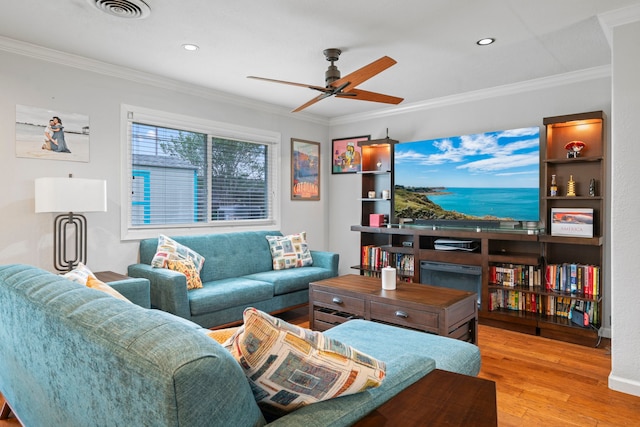 living room featuring crown molding, ceiling fan, and wood finished floors