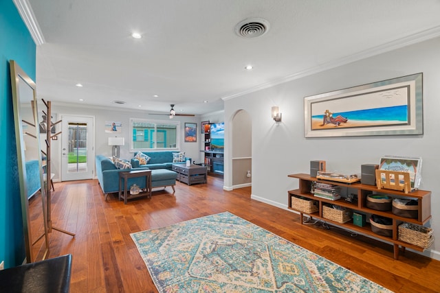 living room with crown molding, recessed lighting, visible vents, and wood-type flooring