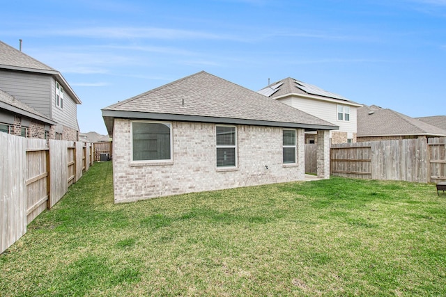 4984 Pismo Ray Dr, Katy, TX 77493 - rear view of house featuring a fenced backyard, brick siding, a shingled roof, and a lawn