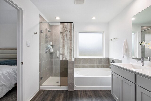 4984 Pismo Ray Dr, Katy, TX 77493 - ensuite bathroom featuring a bath, ensuite bathroom, wood finished floors, and a stall shower