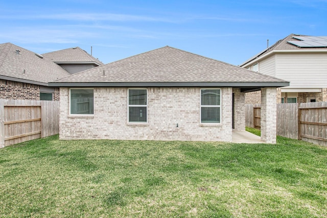 4984 Pismo Ray Dr, Katy, TX 77493 - rear view of property with a fenced backyard, a lawn, a shingled roof, and brick siding