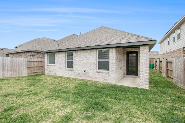 4984 Pismo Ray Dr, Katy, TX 77493 - rear view of property featuring a fenced backyard, a yard, brick siding, and roof with shingles