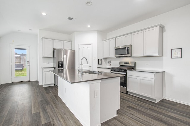 4984 Pismo Ray Dr, Katy, TX 77493 - kitchen with visible vents, stainless steel appliances, a center island with sink, dark wood finished floors, and a sink