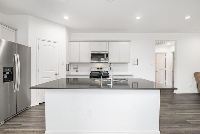 4984 Pismo Ray Dr, Katy, TX 77493 - kitchen with dark wood finished floors, dark countertops, a sink, and stainless steel appliances