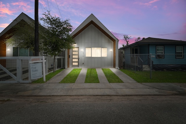view of front facade featuring board and batten siding and fence