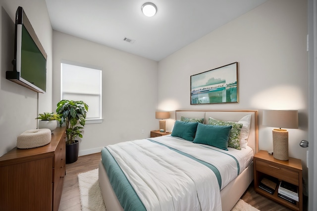 bedroom featuring wood finished floors and baseboards