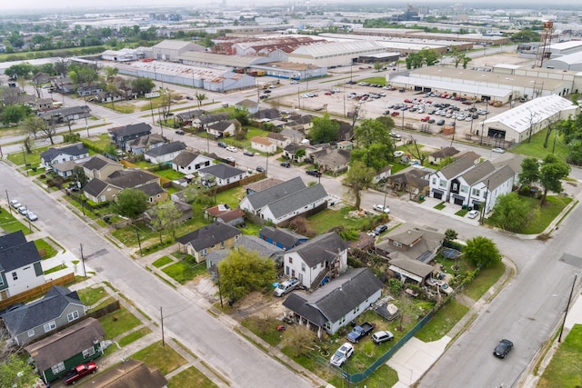 aerial view of property and surrounding area featuring nearby suburban area and an industrial area
