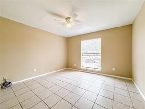 empty room with light tile patterned floors, baseboards, and ceiling fan