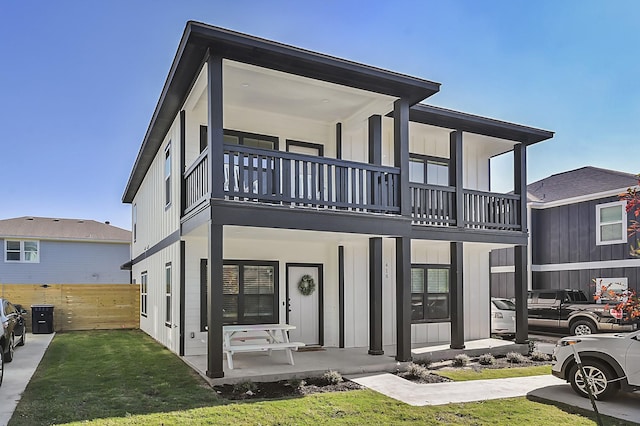 416,418,420 Edward Street, College Station, TX 77840 - view of front of house with a balcony, fence, board and batten siding, and a porch