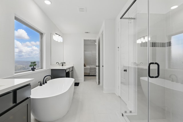21134 Coral View Dr, Cypress, TX 77433 - ensuite bathroom with a shower stall, tile patterned floors, a freestanding tub, vanity, and ensuite bath
