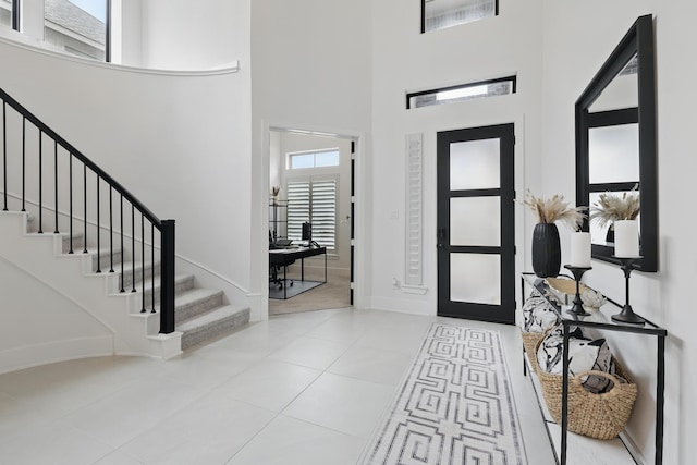 21134 Coral View Dr, Cypress, TX 77433 - entrance foyer featuring tile patterned flooring, baseboards, a towering ceiling, and stairs