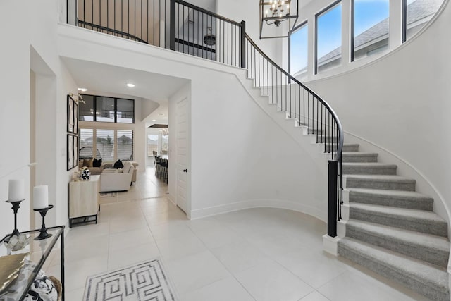 21134 Coral View Dr, Cypress, TX 77433 - stairway with a chandelier, a wealth of natural light, a towering ceiling, and tile patterned flooring
