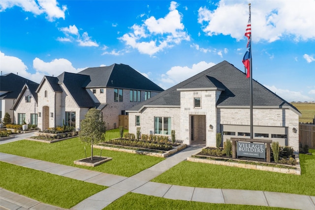 31319 Hastings Creek Ln, Fulshear, TX 77441 - french country style house with stone siding, a front lawn, and brick siding