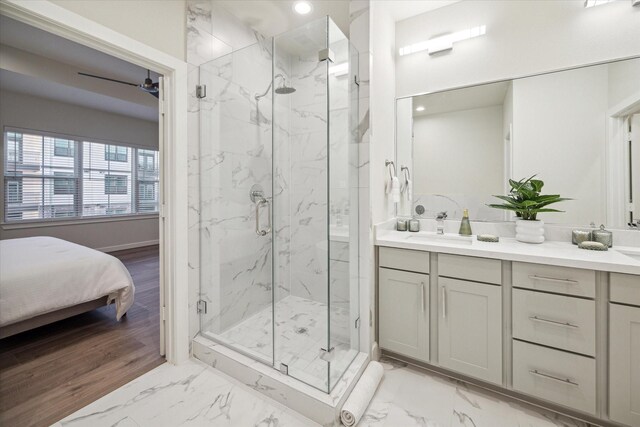 full bath with marble finish floor, vanity, a marble finish shower, and recessed lighting