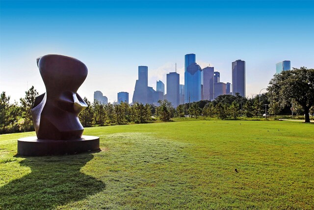 view of home's community featuring a city view and a yard