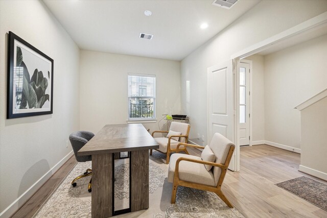 office area featuring baseboards, visible vents, and light wood-style floors