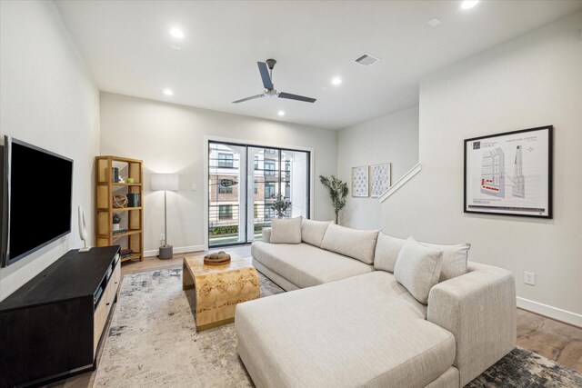 living area featuring baseboards, ceiling fan, recessed lighting, and light wood finished floors