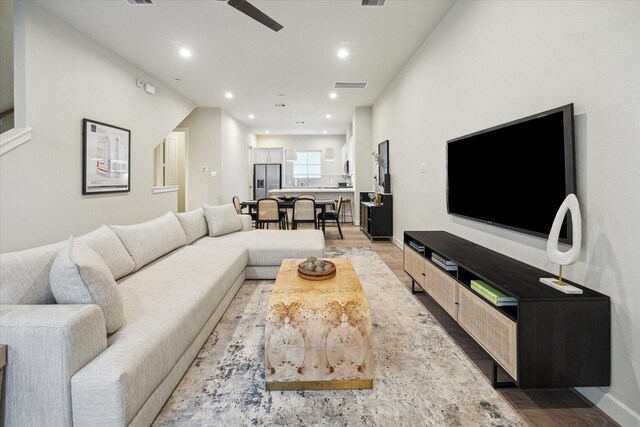 living area featuring a ceiling fan, visible vents, recessed lighting, and light wood-type flooring
